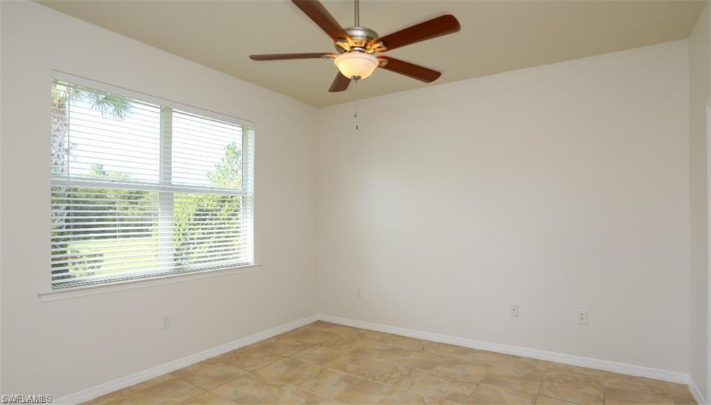 8482 Karina Court Naples, FL 34114 - Photo 19 of 40 a view of a room with a window and a ceiling fan
