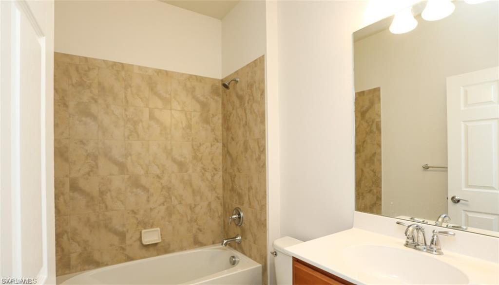 8482 Karina Court Naples, FL 34114 - Photo 20 of 40 a bathroom with a sink and a bathtub