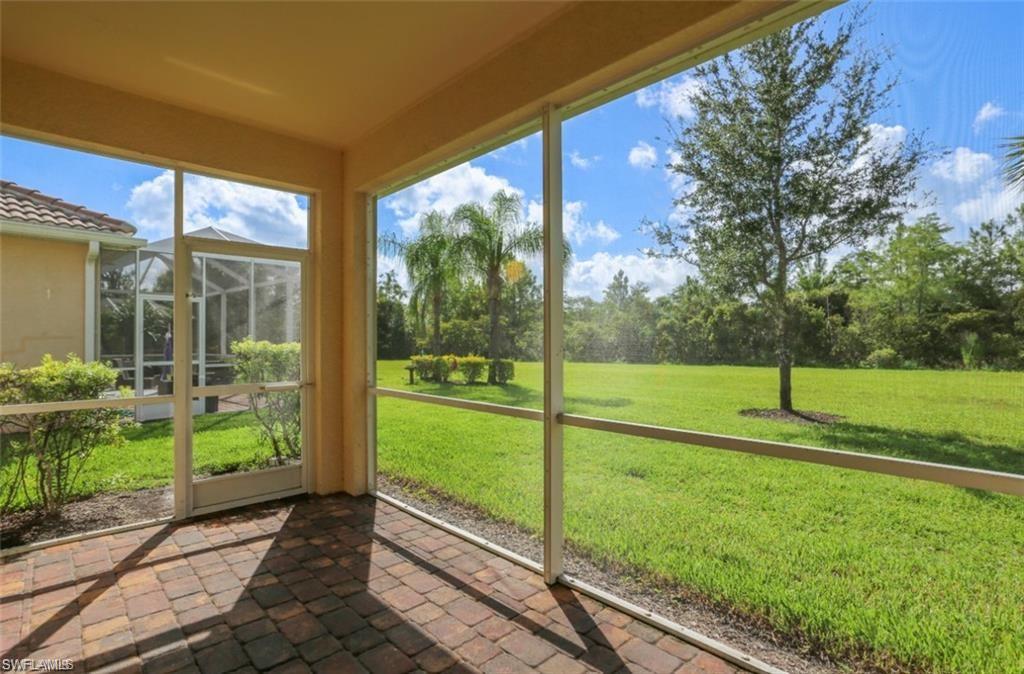 8482 Karina Court Naples, FL 34114 - Photo 22 of 40 a view of a porch and garden