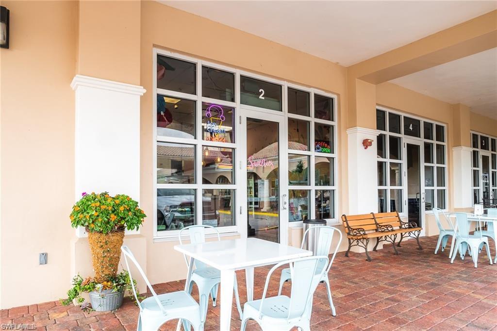 8482 Karina Court Naples, FL 34114 - Photo 39 of 40 a view of a dining room with furniture and a potted plant