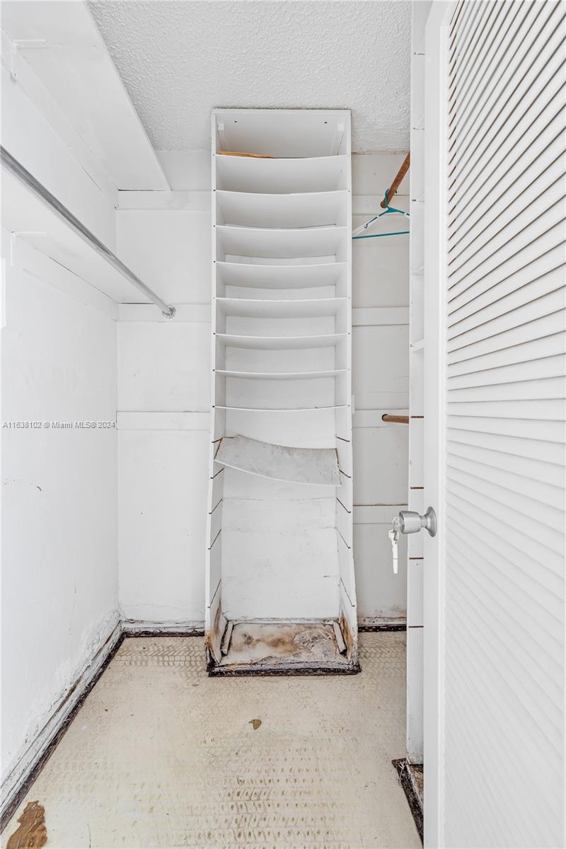 1345 Lincoln Road, Unit PH6 Miami Beach, FL 33139 - Photo 13 of 35 a view of walk in closet with empty racks