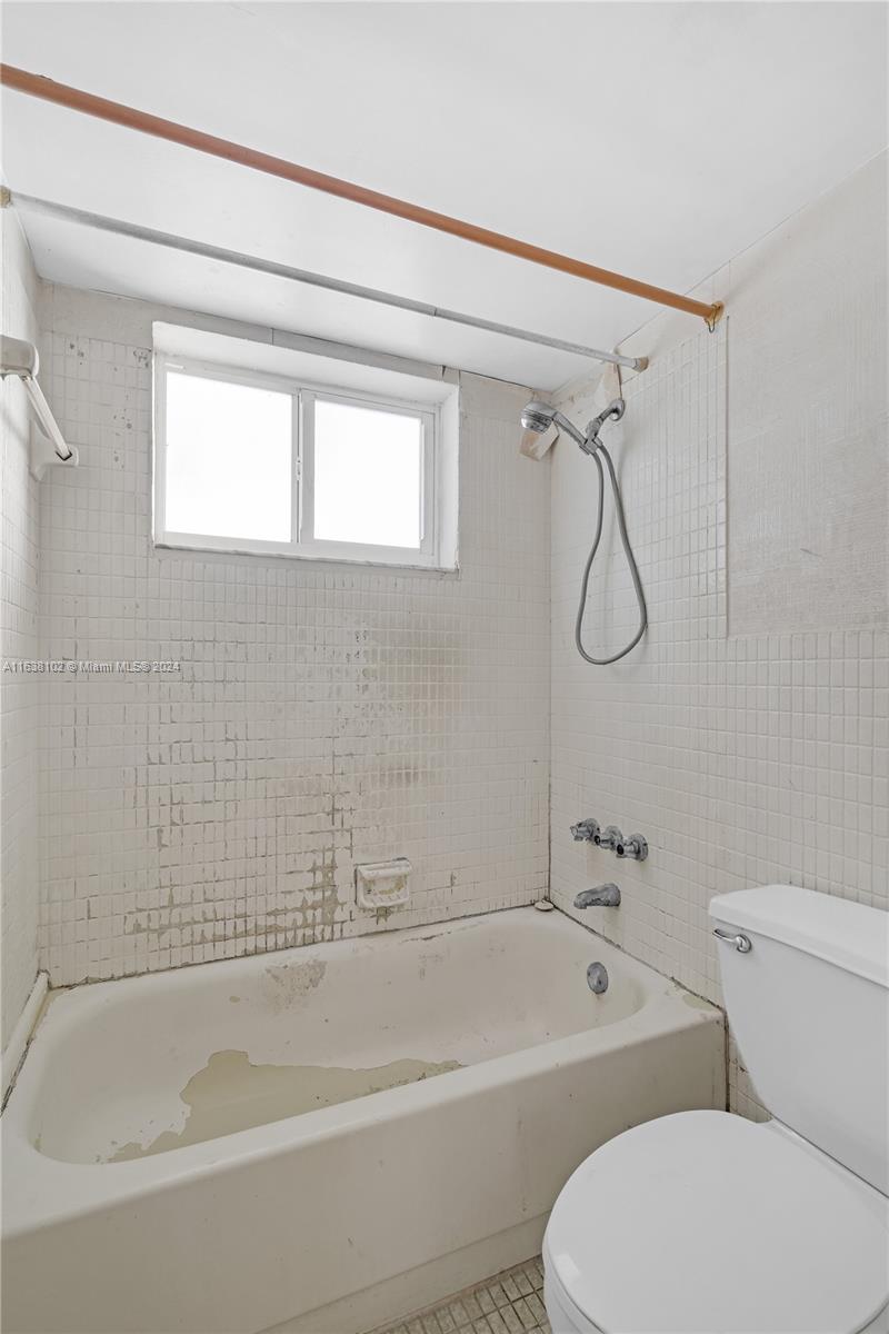 1345 Lincoln Road, Unit PH6 Miami Beach, FL 33139 - Photo 16 of 35 a bathroom with a toilet bathtub and shower