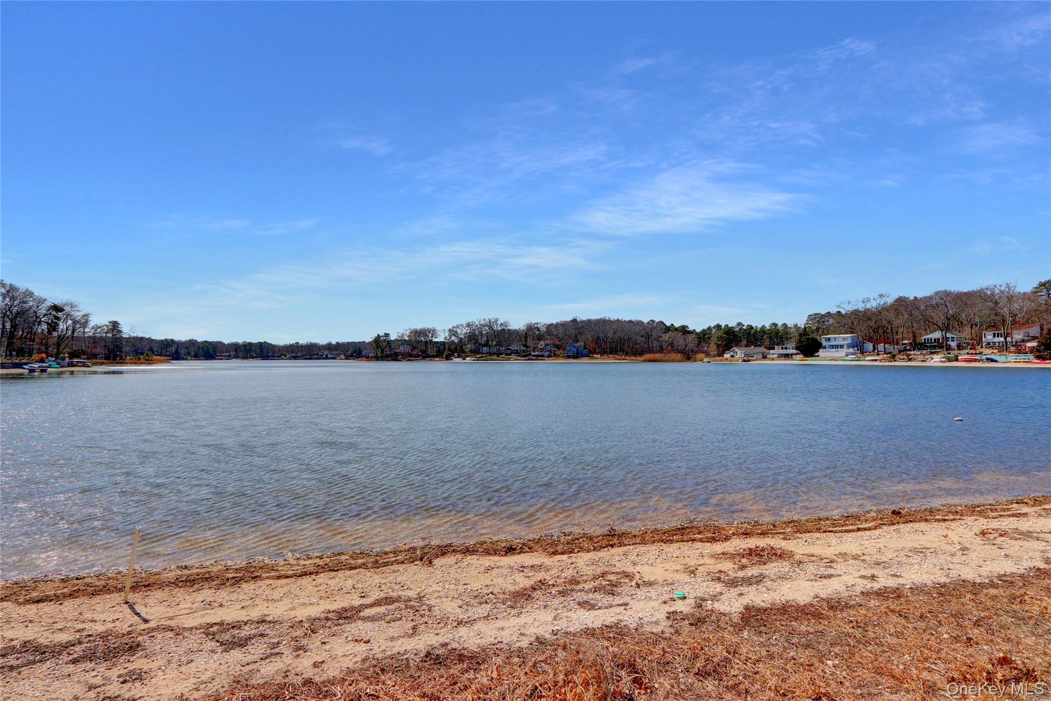 243 Lakeside Trail Ridge, NY 11961 - Photo 32 of 38 a view of a lake with houses in the background