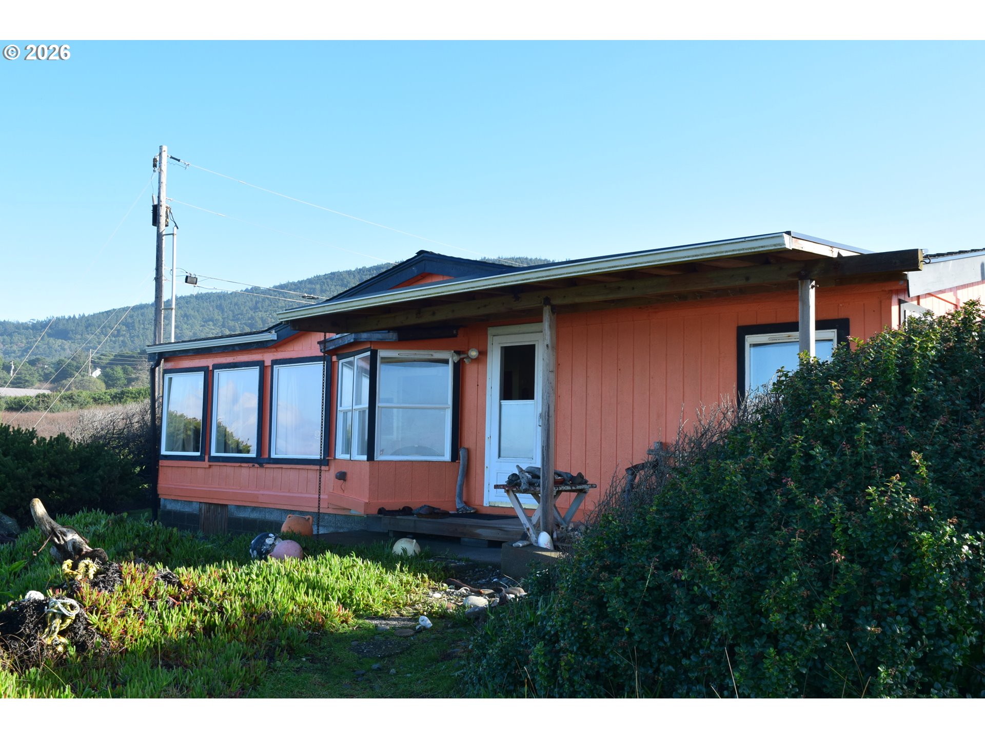 33130 Nesika Road, Unit A Gold Beach, OR 97444 - Photo 12 of 17 a front view of a house with garden