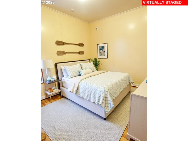 a bedroom with a bed and a wall painting
