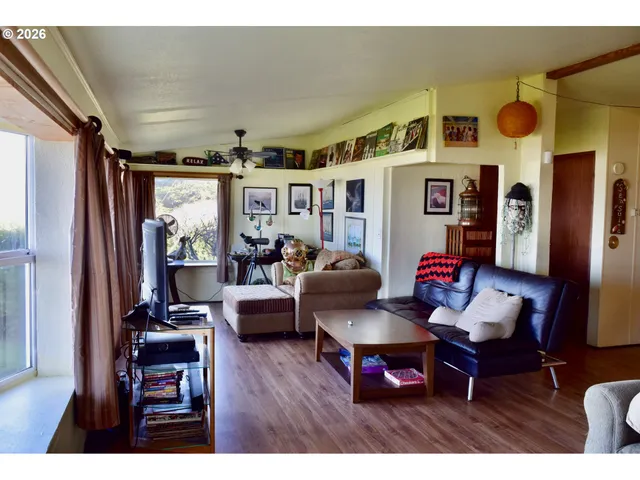 a living room with furniture and a floor to ceiling window
