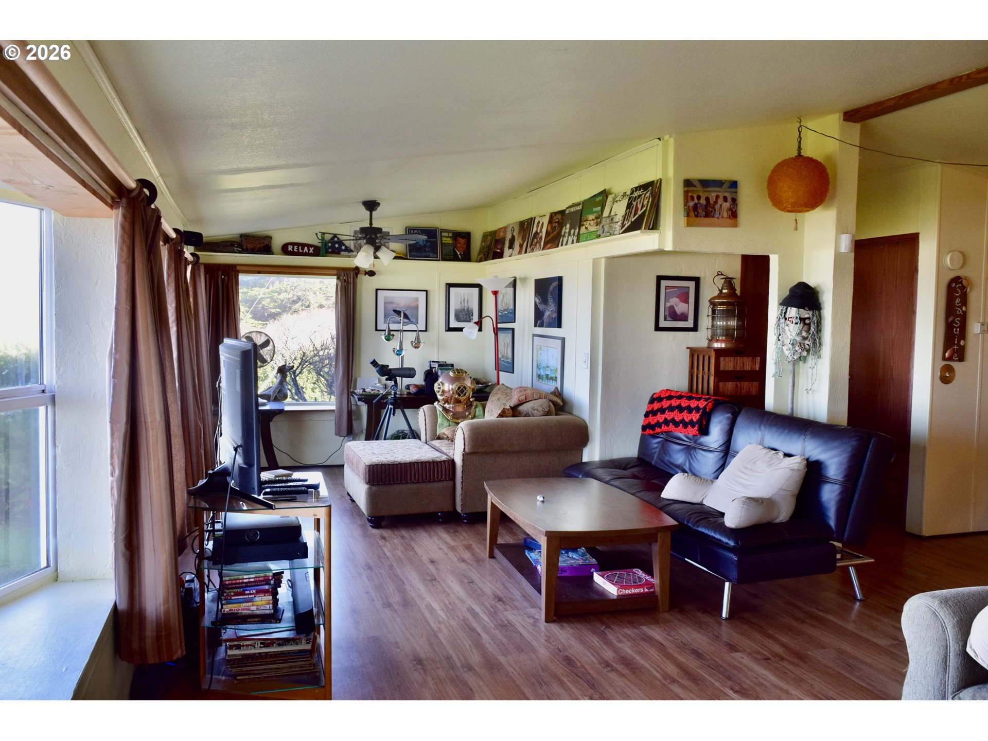 33130 Nesika Road, Unit A Gold Beach, OR 97444 - Photo 3 of 17 a living room with furniture and a floor to ceiling window