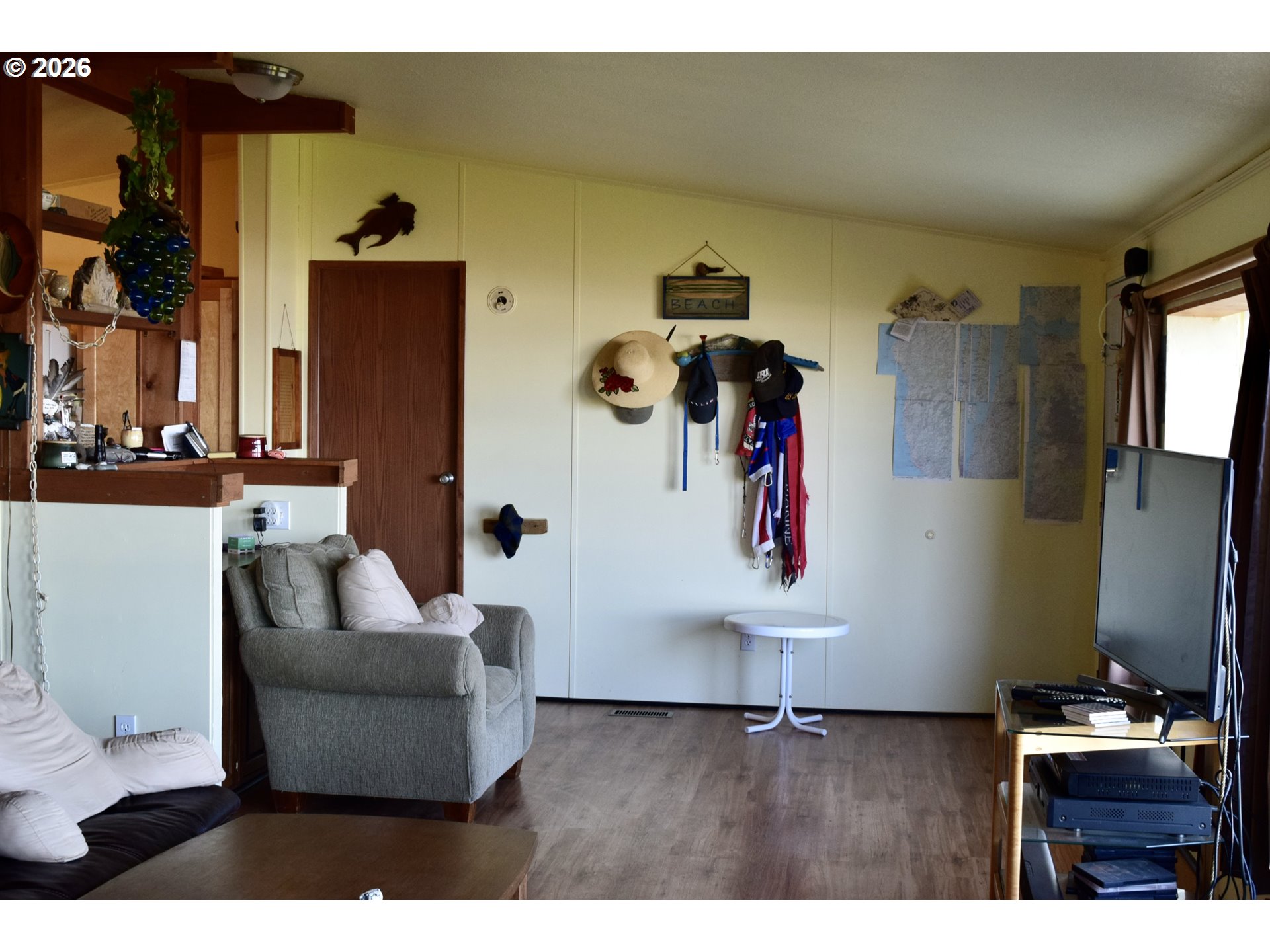 33130 Nesika Road, Unit A Gold Beach, OR 97444 - Photo 5 of 17 a living room with furniture and a flat screen tv