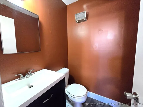 a bathroom with a sink a toilet and mirror