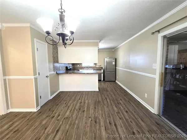 a view of a kitchen from a hallway