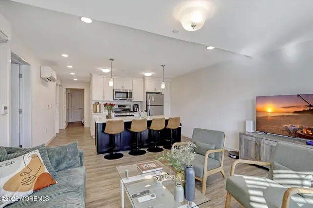 a living room with lots of furniture and kitchen view