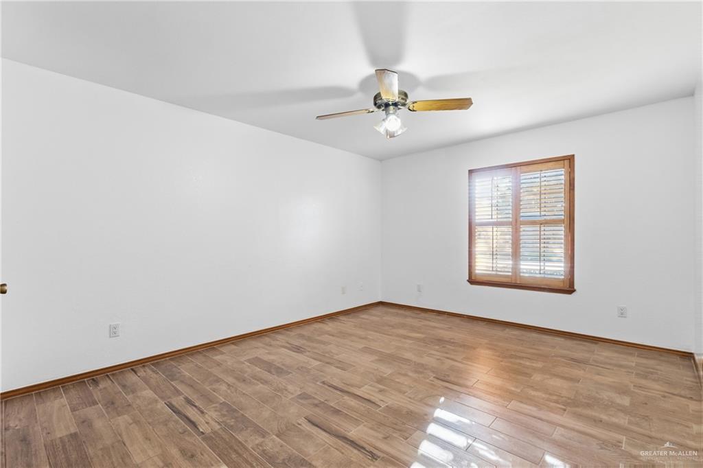 2312 Yarrow Street Mission, TX 78574 - Photo 11 of 20 an empty room with a window and a fan