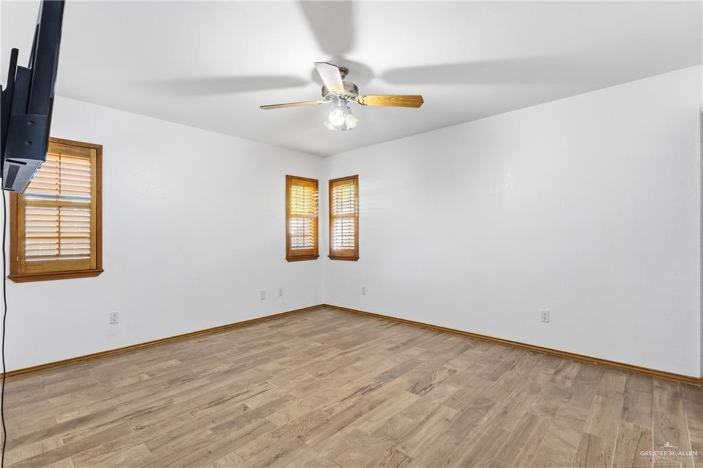 2312 Yarrow Street Mission, TX 78574 - Photo 8 of 20 wooden floor in an empty room with a window