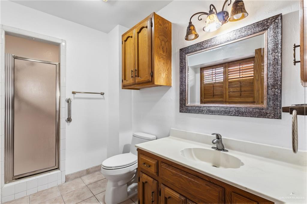 2312 Yarrow Street Mission, TX 78574 - Photo 9 of 20 a bathroom with a sink a toilet and shower