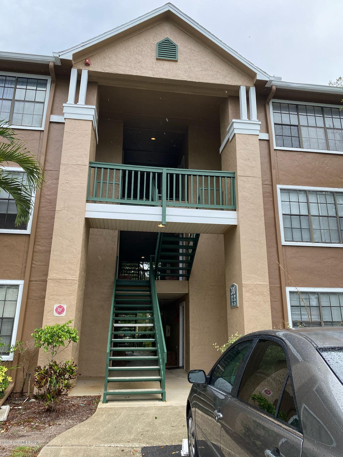 7667 North Wickham Road, Unit 214 Melbourne, FL 32940 - Photo 1 of 16 a front view of a house with stairs
