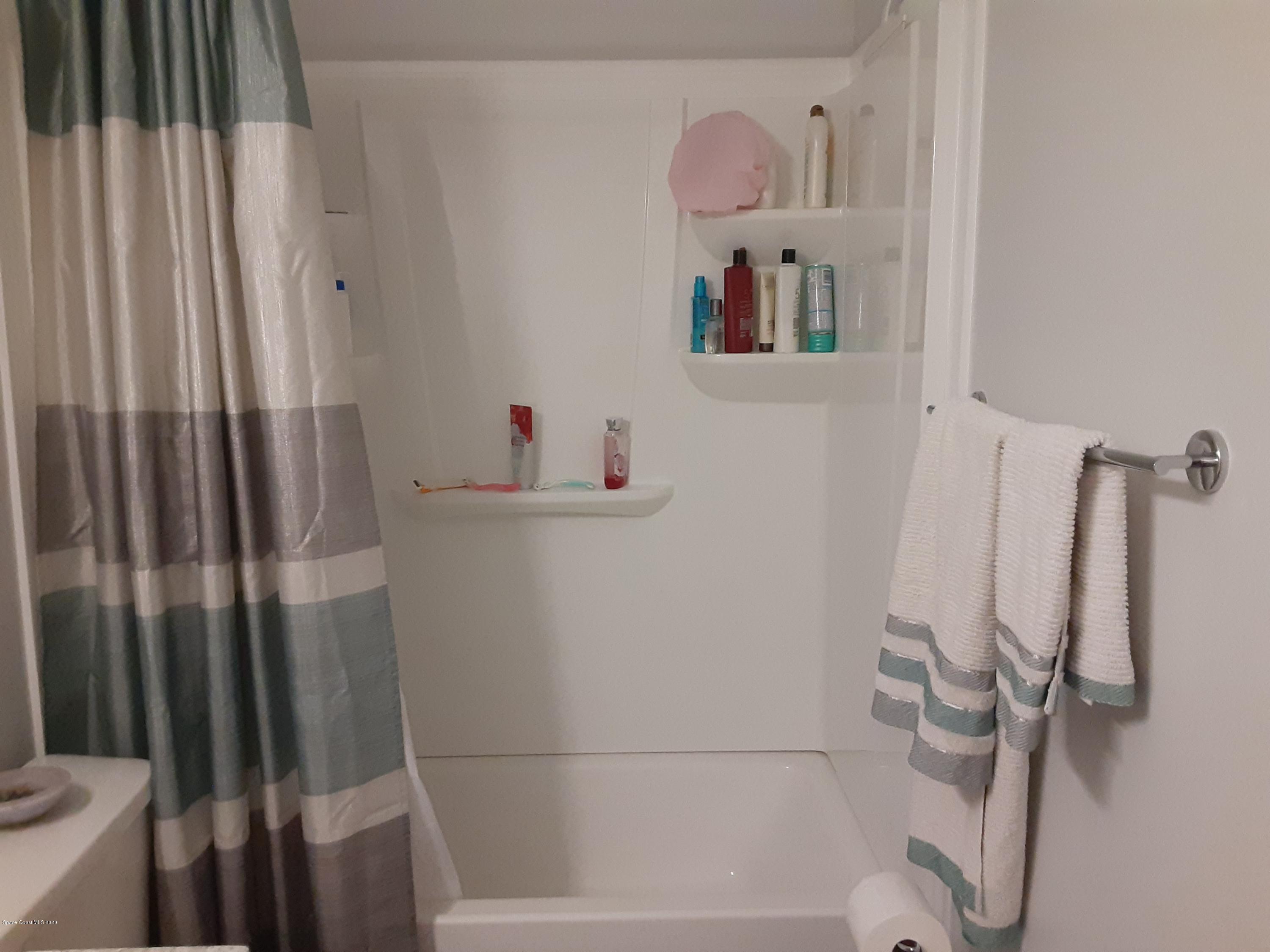 7667 North Wickham Road, Unit 214 Melbourne, FL 32940 - Photo 11 of 16 a bathroom with a bathtub and a shower