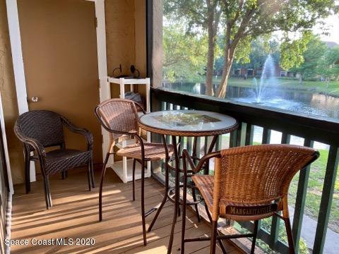 7667 North Wickham Road, Unit 214 Melbourne, FL 32940 - Photo 14 of 16 a view of balcony with table and chairs