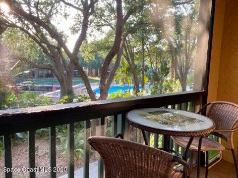 7667 North Wickham Road, Unit 214 Melbourne, FL 32940 - Photo 15 of 16 a view of a balcony with a table and chairs
