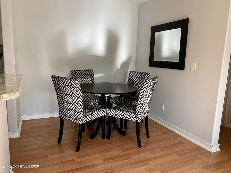 7667 North Wickham Road, Unit 214 Melbourne, FL 32940 - Photo 4 of 16 a view of a dining room with furniture and wooden floor