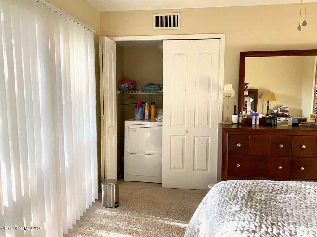 7667 North Wickham Road, Unit 214 Melbourne, FL 32940 - Photo 9 of 16 a bedroom with a bed and a dresser