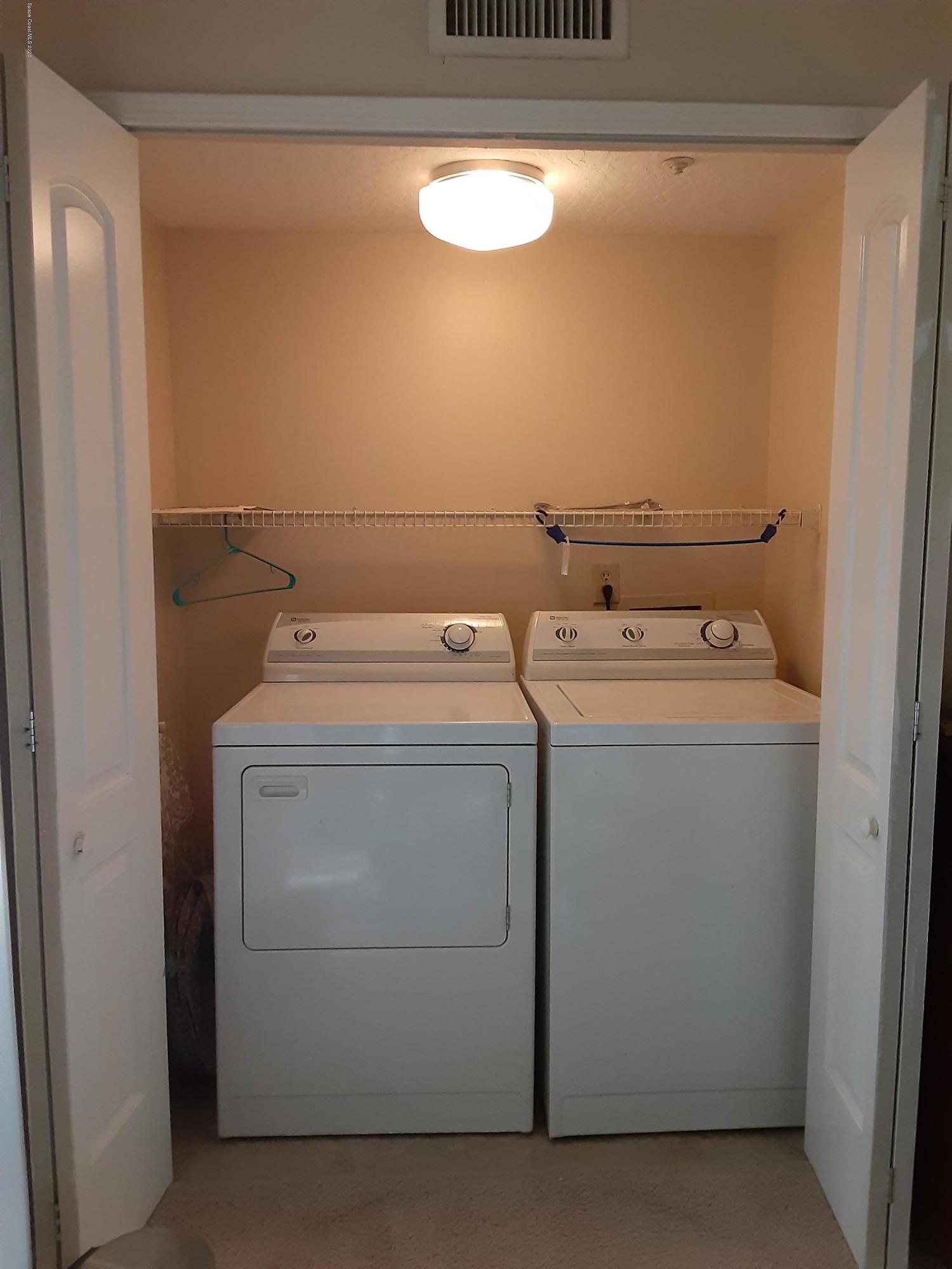 7667 North Wickham Road, Unit 214 Melbourne, FL 32940 - Photo 10 of 16 a utility room with dryer and washer