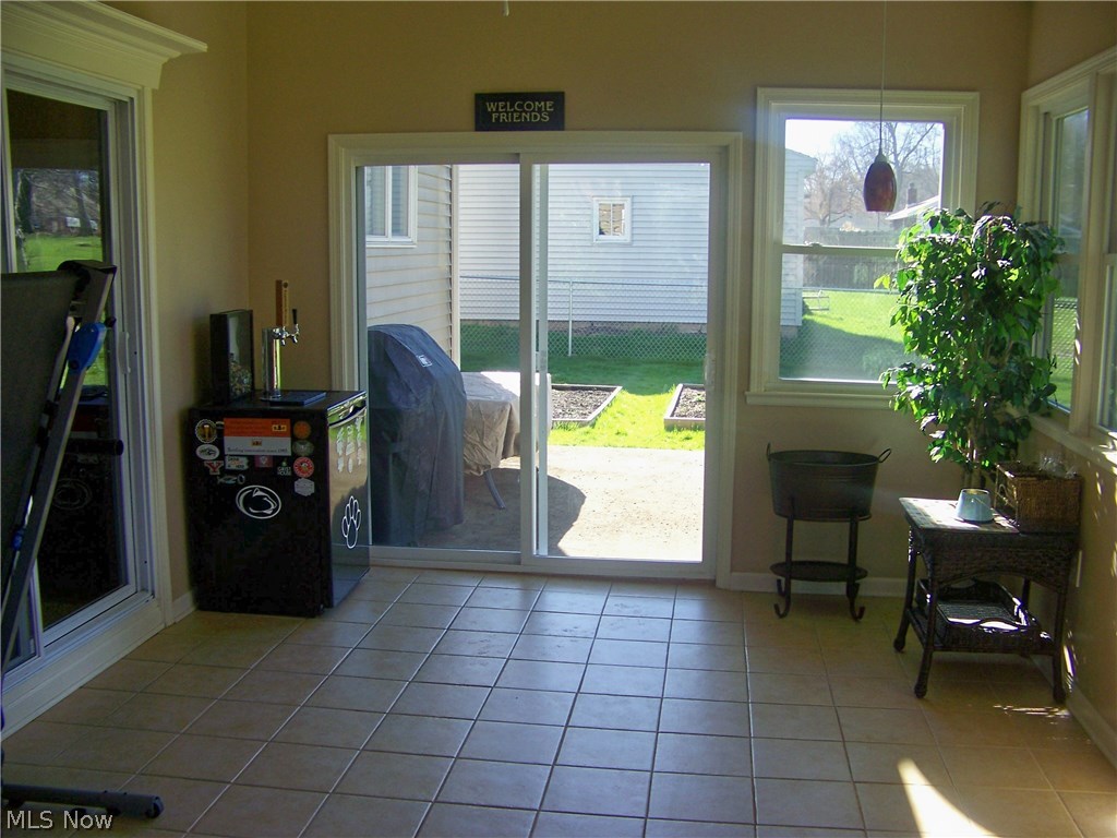 416 Ewing Road Youngstown, OH 44512 - Photo 20 of 34 SUN ROOM LEADING TO CONCRETE PATIO