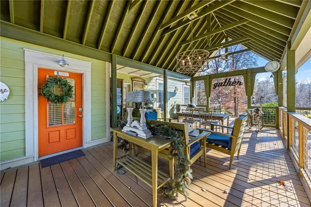a living room with furniture a rug and wall paintings