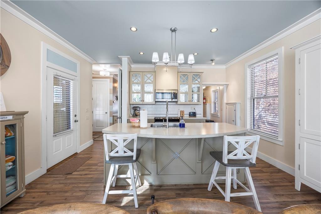 243 Bluegill Road Eatonton, GA 31024 - Photo 17 of 144 a dining room with kitchen island stainless steel appliances furniture a large window and wooden floor