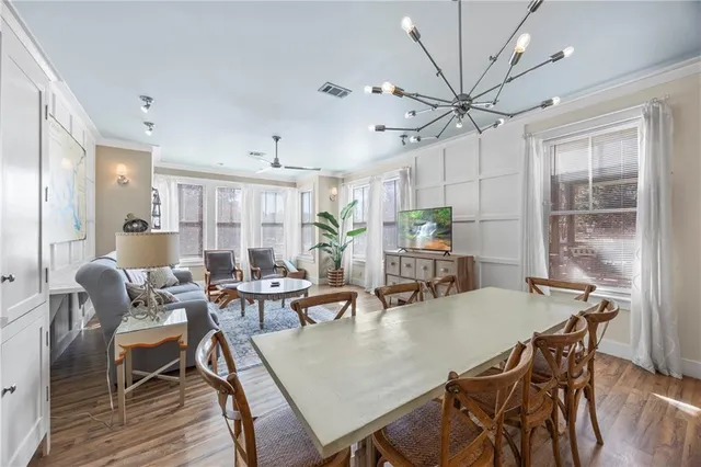a view of a hallway with wooden floor and closet
