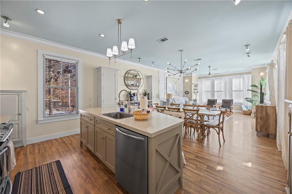 243 Bluegill Road Eatonton, GA 31024 - Photo 23 of 144 a kitchen with stove a dining table chairs and wooden floor