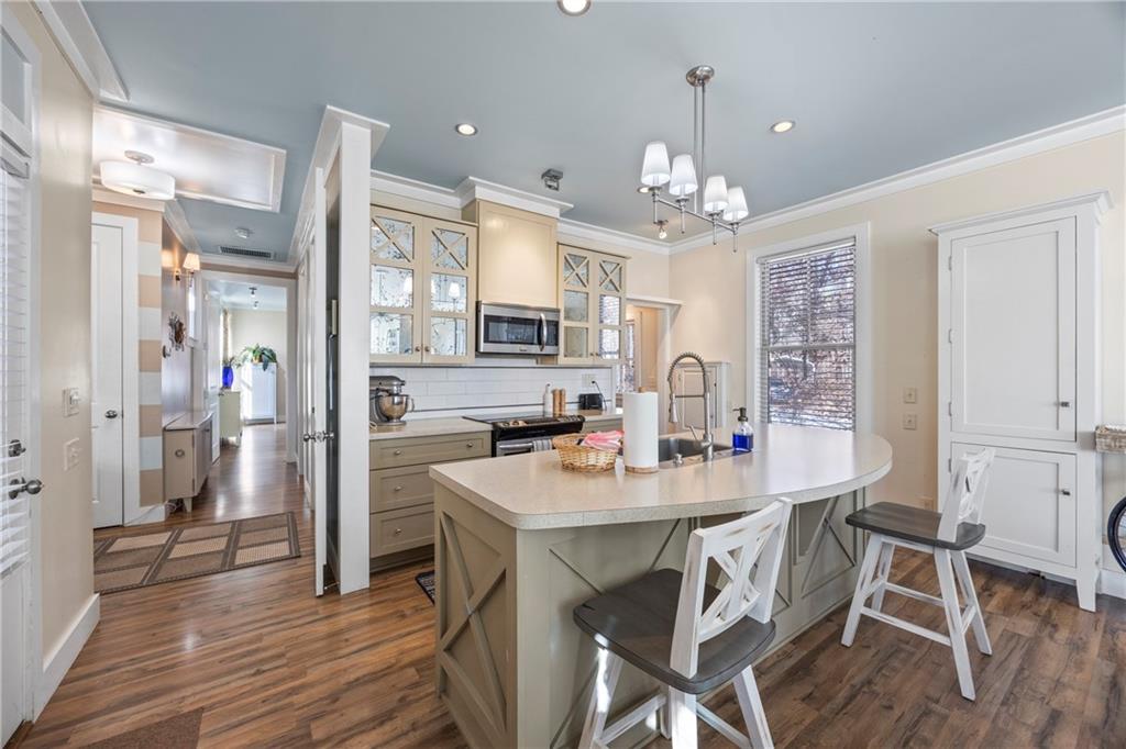 243 Bluegill Road Eatonton, GA 31024 - Photo 25 of 144 a view of a dining room and livingroom with furniture wooden floor a chandelier