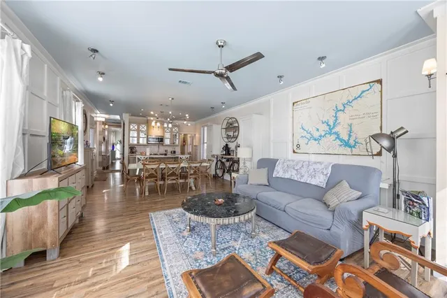 a living room with furniture and a wooden floor