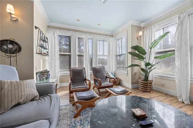 a bedroom with a bed and a table with wooden floor