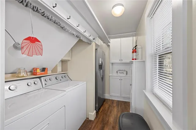 a living room with furniture a window and a flat screen tv