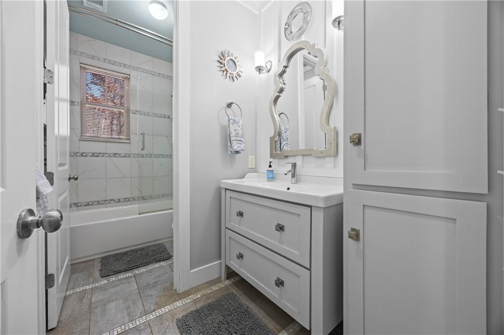 243 Bluegill Road Eatonton, GA 31024 - Photo 4 of 144 a bathroom with a double vanity sink mirror and bathtub
