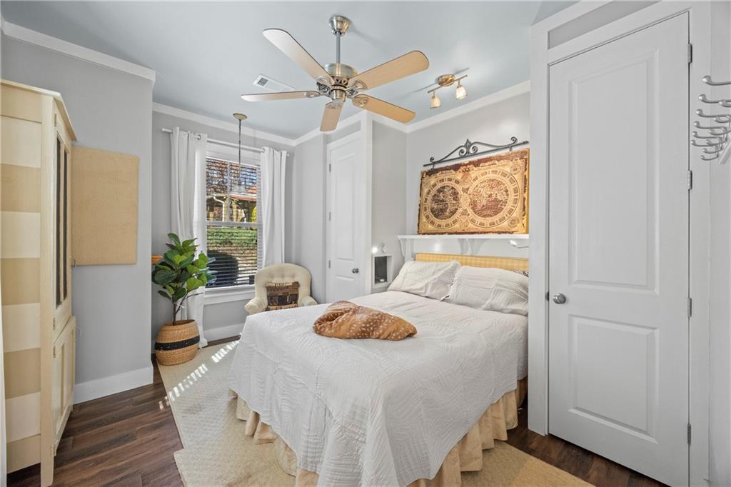 243 Bluegill Road Eatonton, GA 31024 - Photo 79 of 144 a bedroom with a bed and a table with wooden floor