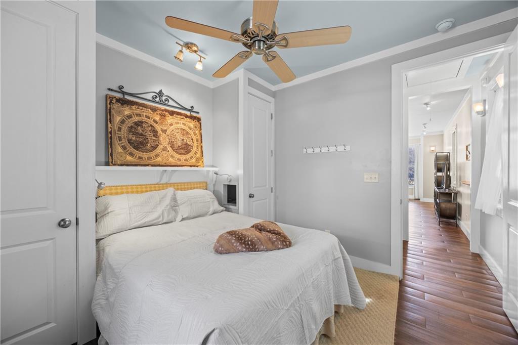 243 Bluegill Road Eatonton, GA 31024 - Photo 81 of 144 a bedroom with a bed and a chandelier