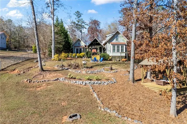 a view of a dining room and livingroom with furniture wooden floor a chandelier