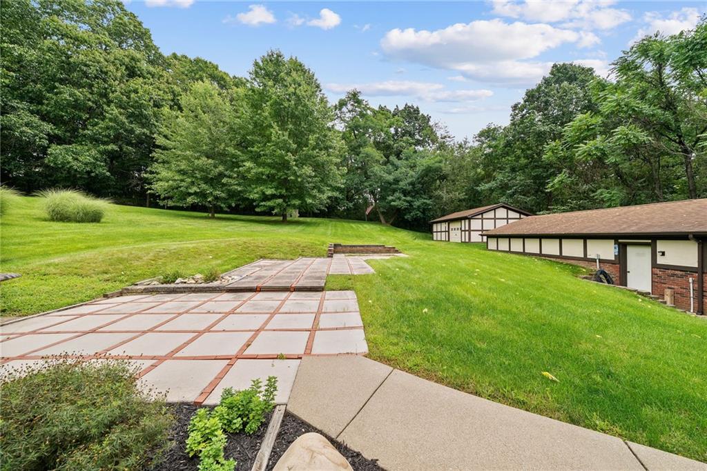 94 Ohare Road Canonsburg, PA 15317 - Photo 44 of 50 A backyard with room to breathe, featuring a large patio, sweeping lawn, mature trees, and access to the detached garage.