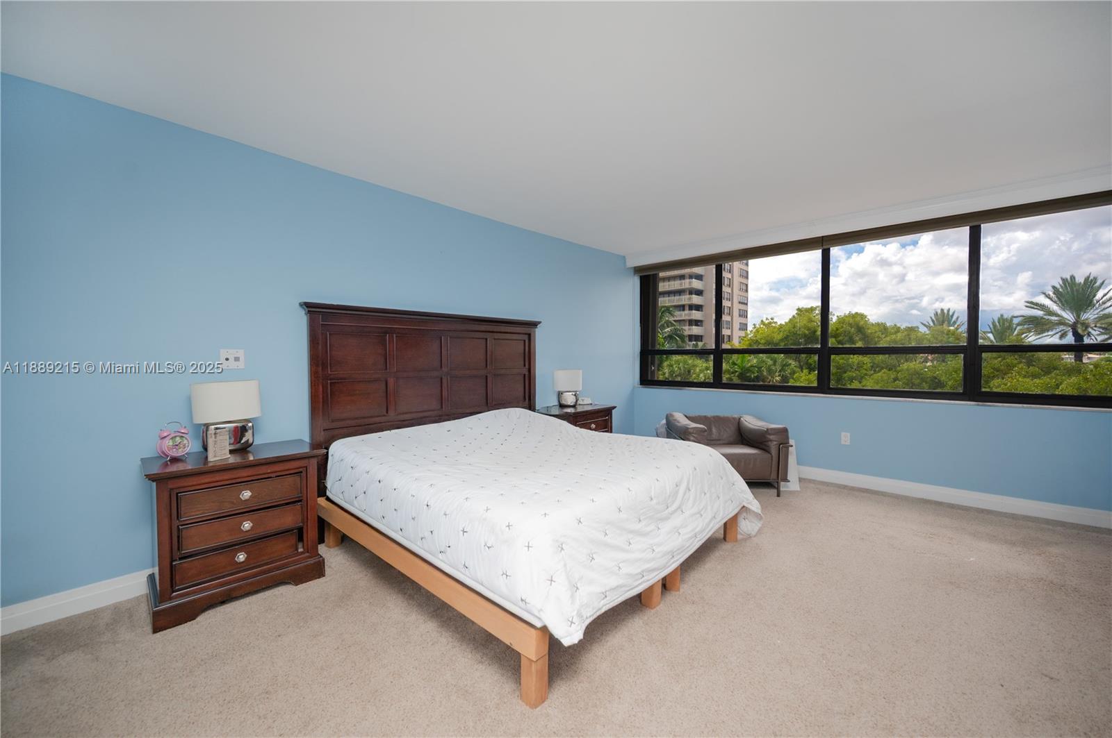 3 Grove Isle Drive, Unit C308 Miami, FL 33133 - Photo 12 of 54 a bed sitting in a bedroom next to a window