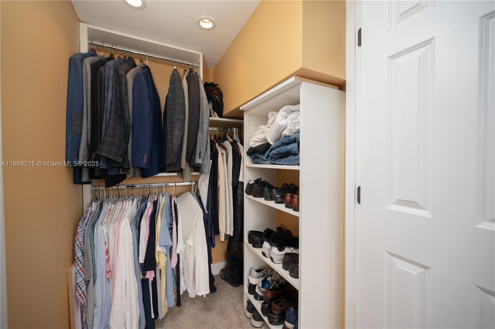 3 Grove Isle Drive, Unit C308 Miami, FL 33133 - Photo 18 of 54 a view of walk in closet with clothes and shoes