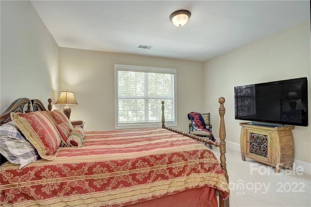 905 Ospre Lane Fort Mill, SC 29708 - Photo 18 of 35 a bedroom with a bed and a flat screen tv