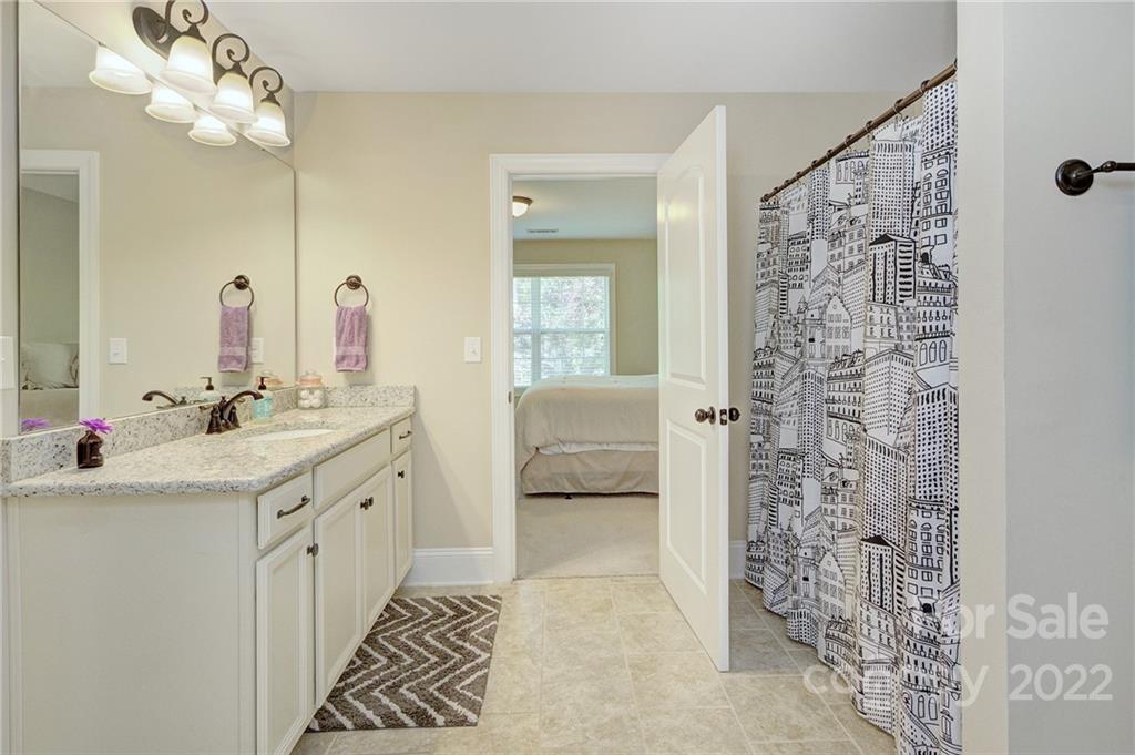 905 Ospre Lane Fort Mill, SC 29708 - Photo 22 of 35 a spacious bathroom with a shower a sink and a mirror
