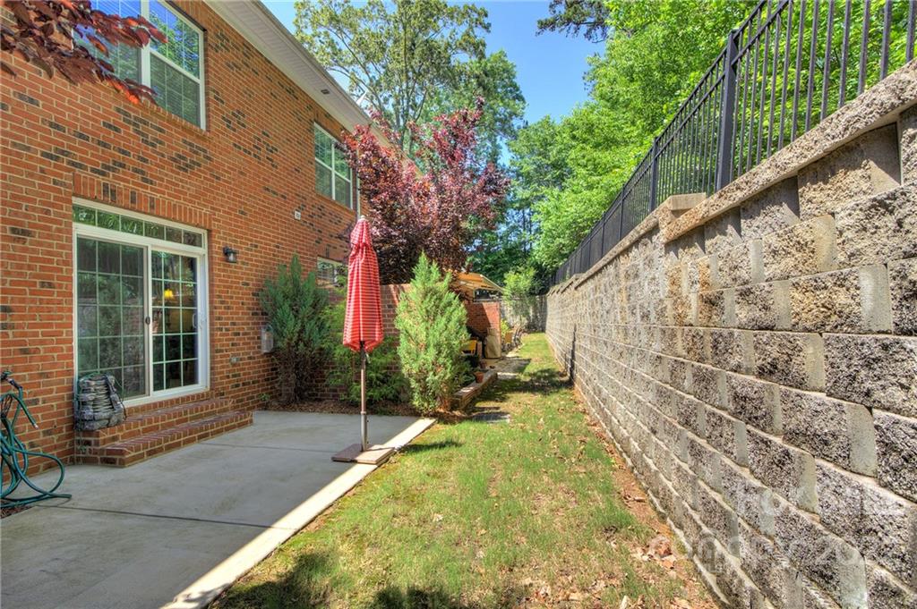 905 Ospre Lane Fort Mill, SC 29708 - Photo 29 of 35 a view of yellow house with large windows and a small yard