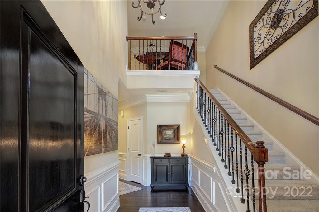 905 Ospre Lane Fort Mill, SC 29708 - Photo 4 of 35 a view of a hallway with wooden floor and staircase