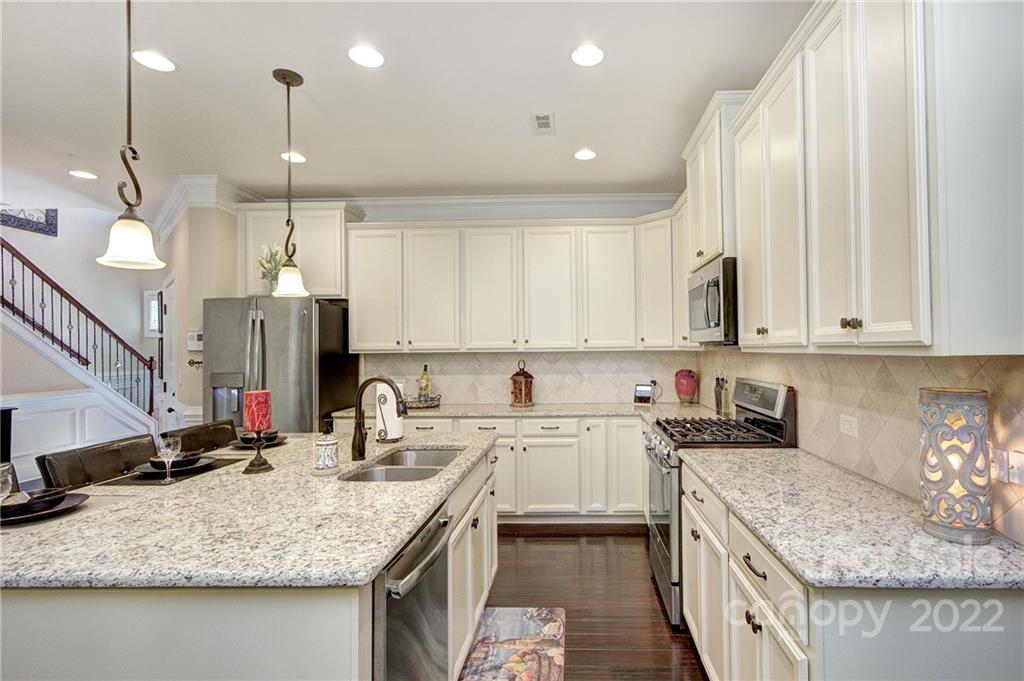 905 Ospre Lane Fort Mill, SC 29708 - Photo 7 of 35 a kitchen with stainless steel appliances granite countertop a sink stove and cabinets