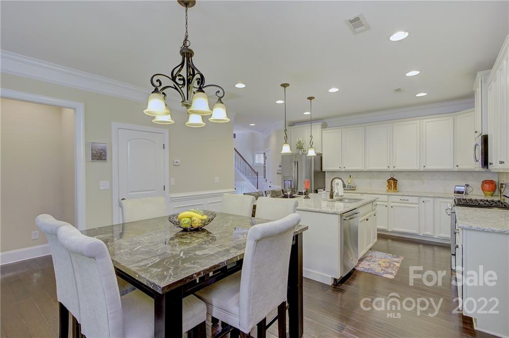 905 Ospre Lane Fort Mill, SC 29708 - Photo 8 of 35 a kitchen with a dining table chairs and sink