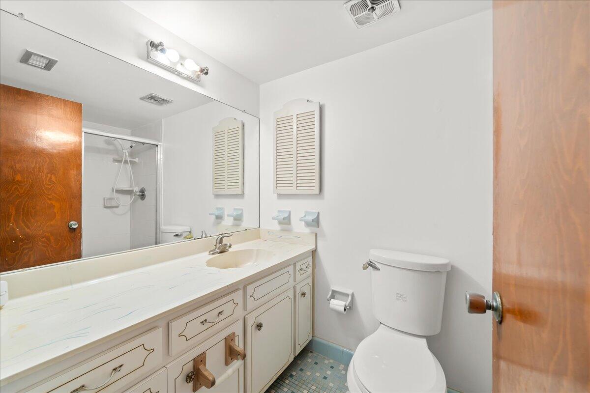 2862 Starlight Circle Northeast Palm Bay, FL 32905 - Photo 17 of 45 a bathroom with a double vanity sink mirror and toilet