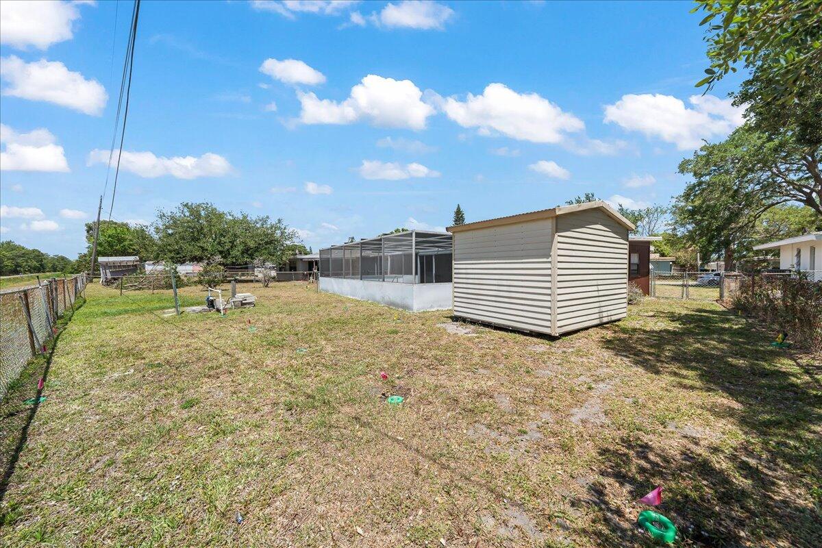 2862 Starlight Circle Northeast Palm Bay, FL 32905 - Photo 33 of 45 a backyard of a house with a yard and outdoor seating