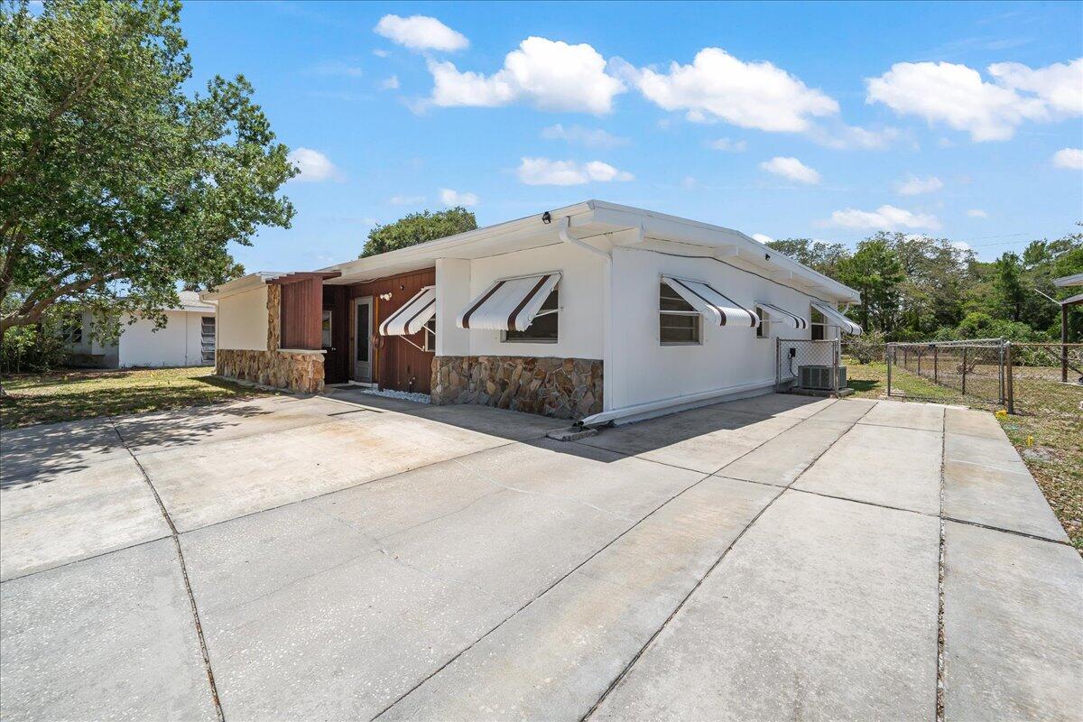 2862 Starlight Circle Northeast Palm Bay, FL 32905 - Photo 5 of 45 a view of a white house with a yard